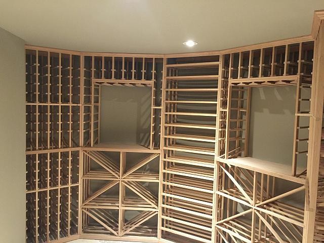 Inspiration for a mid-sized contemporary wine cellar in Toronto with ceramic floors, storage racks and beige floor.