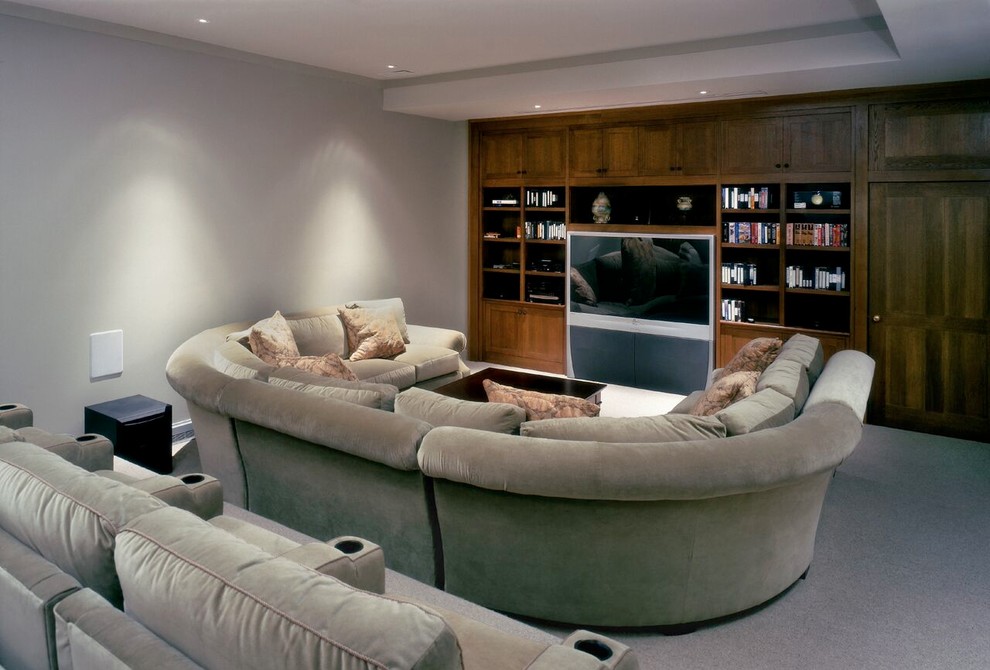 Photo of a mid-sized traditional enclosed home theatre in Other with grey walls, carpet, a wall-mounted tv and grey floor.
