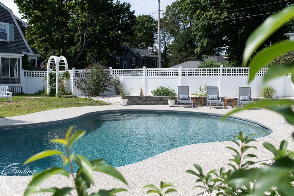 Inspiration for a mid-sized modern backyard kidney-shaped natural pool in Boston with concrete slab.
