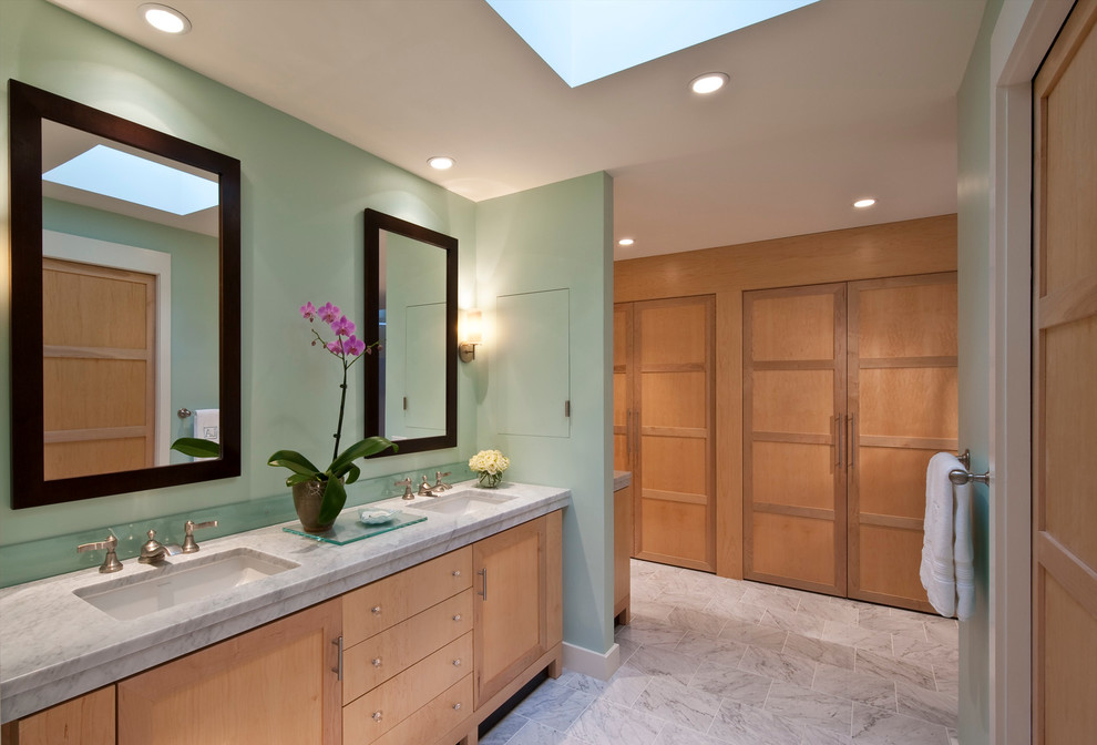 Expansive transitional master bathroom in Philadelphia with shaker cabinets, light wood cabinets, an alcove tub, an alcove shower, a one-piece toilet, green tile, porcelain tile, green walls, marble floors, an undermount sink and marble benchtops.