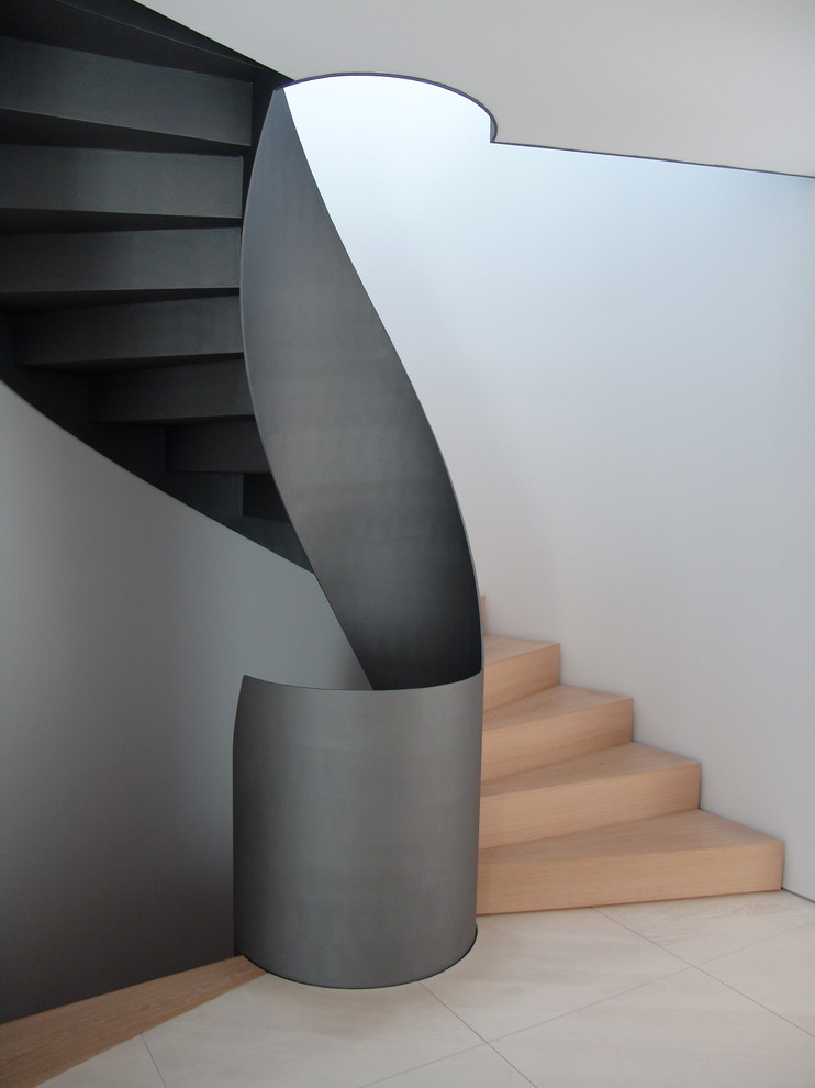 Inspiration for a mid-sized contemporary wood curved staircase in Nuremberg with wood risers.