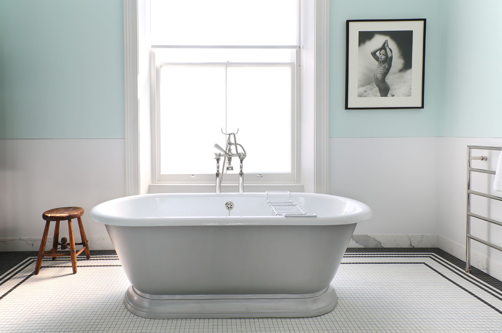 Photo of a bathroom in London with a freestanding bath, white tiles, blue walls and mosaic tile flooring.