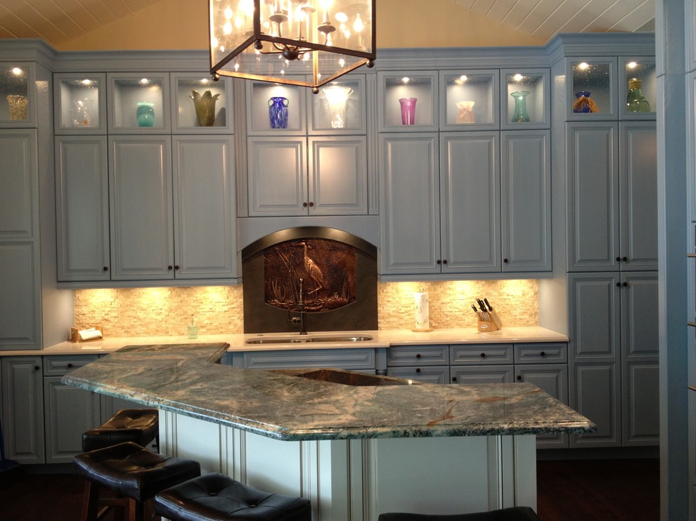 Eat-in kitchen - transitional eat-in kitchen idea in Miami with raised-panel cabinets, blue cabinets and an island