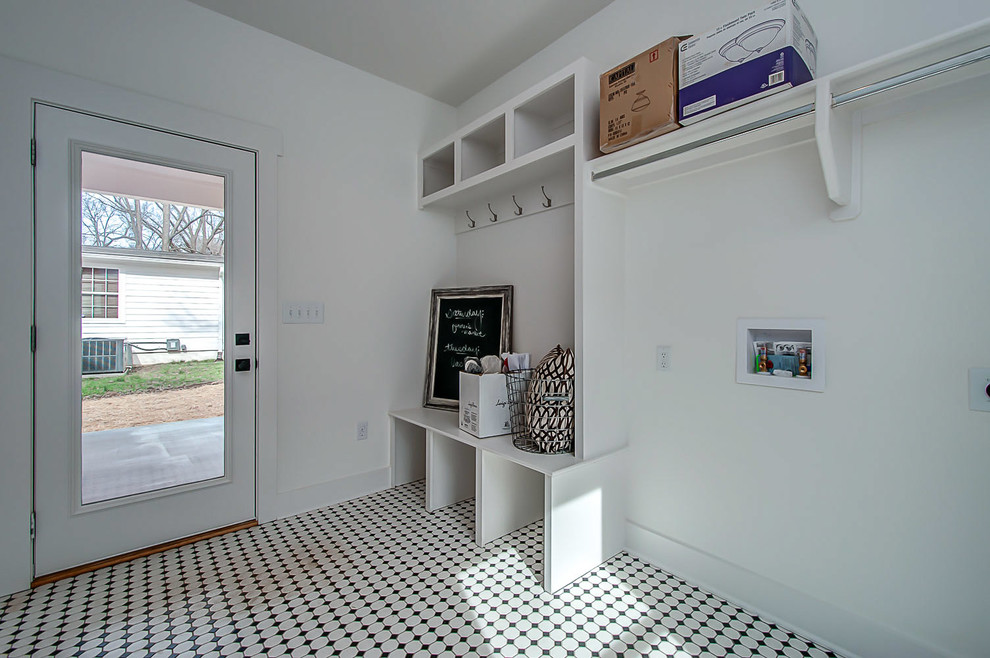 Design ideas for a mid-sized country entryway in Nashville with white walls and porcelain floors.