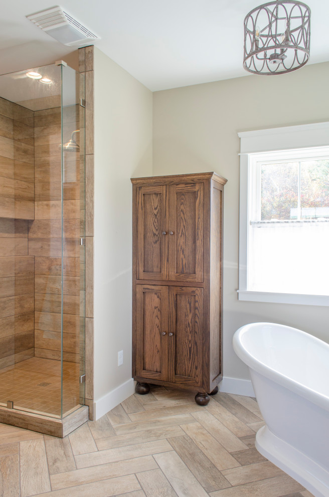 This is an example of a medium sized rural ensuite bathroom in Columbus with shaker cabinets, dark wood cabinets, a freestanding bath, a walk-in shower, wood-effect flooring, brown floors, an open shower and a wall niche.