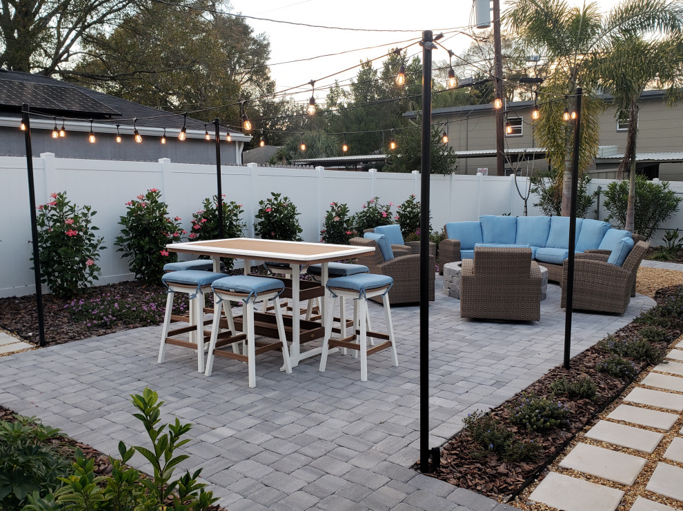 Design ideas for a medium sized nautical front patio in Tampa with a fire feature and concrete paving.