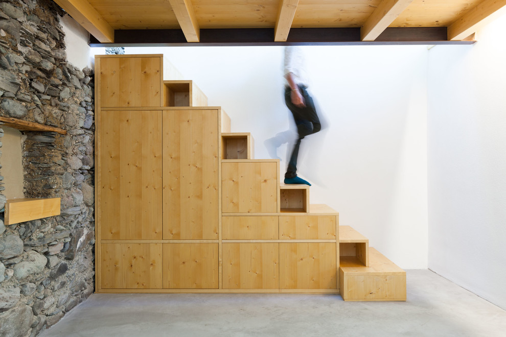 This is an example of a mid-sized country wood straight staircase in Other with wood risers.