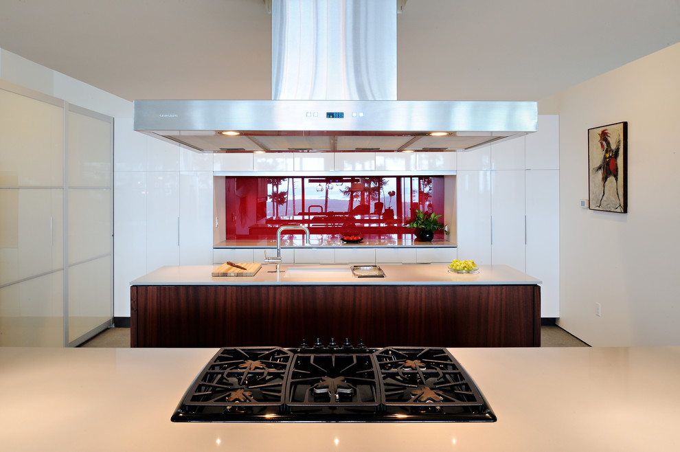 Design ideas for a mid-sized contemporary galley eat-in kitchen in Seattle with a double-bowl sink, flat-panel cabinets, dark wood cabinets, solid surface benchtops, white splashback, stone slab splashback, stainless steel appliances, concrete floors and with island.