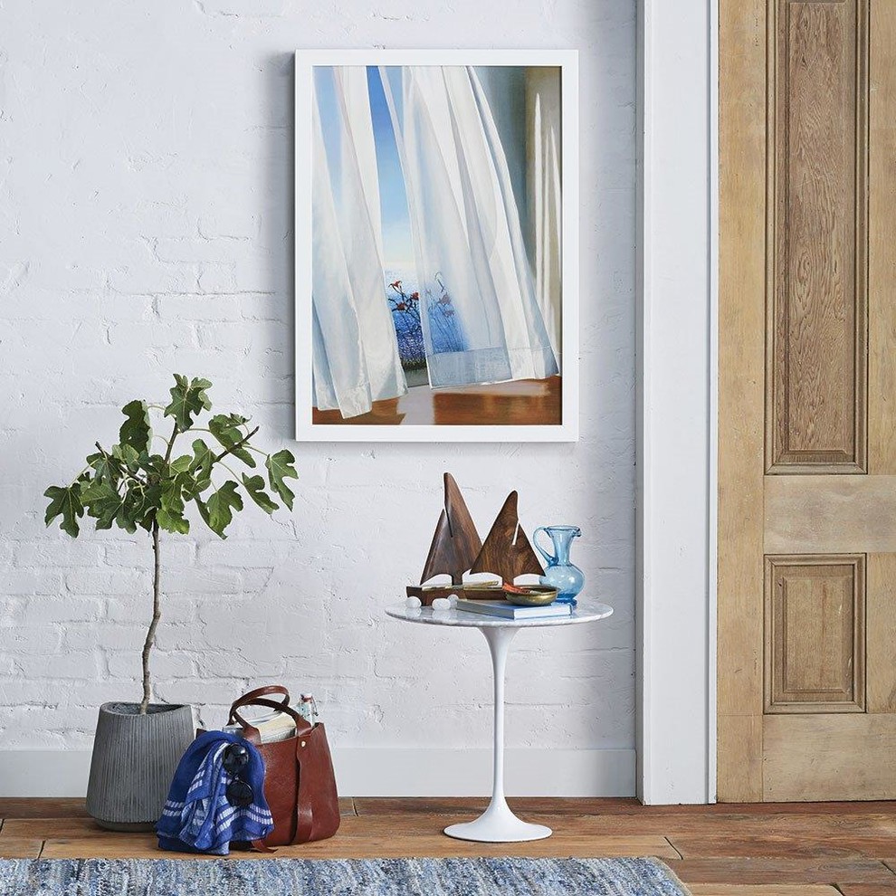 Photo of a mid-sized beach style foyer in San Francisco with white walls and light hardwood floors.