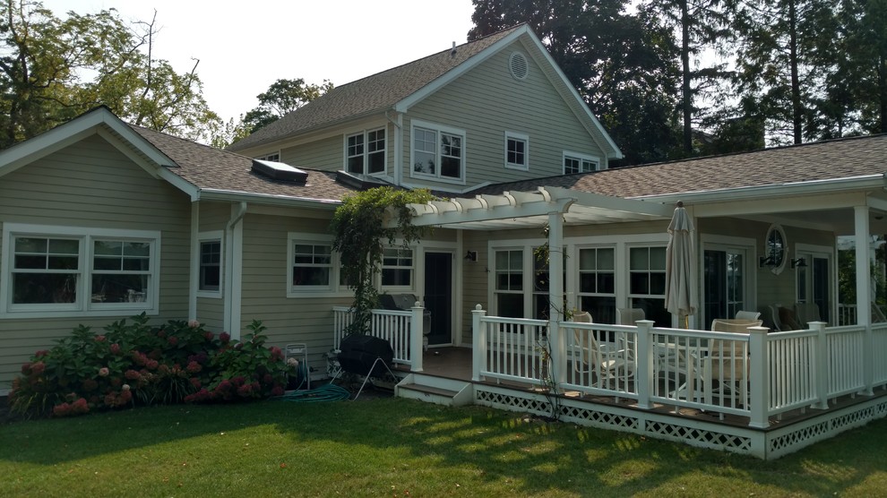Design ideas for a large traditional backyard verandah in New York with decking and a pergola.