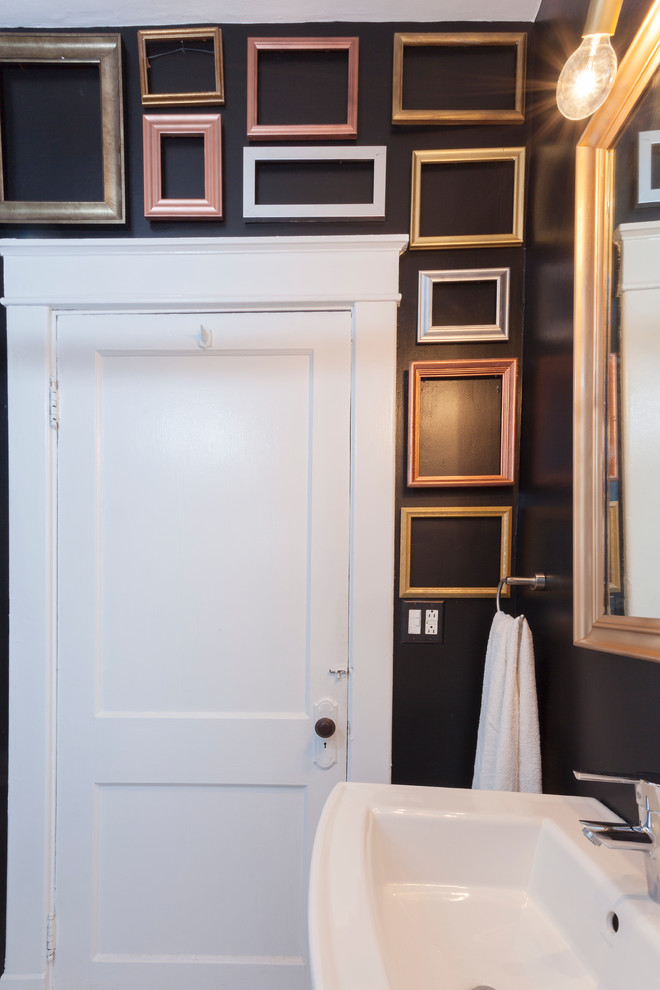 This is an example of a small eclectic 3/4 bathroom in Nashville with a pedestal sink and black walls.