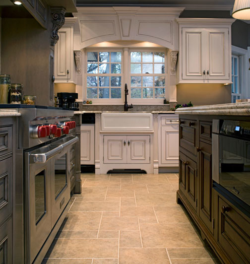 Photo of a traditional l-shaped eat-in kitchen in Baltimore with a farmhouse sink, raised-panel cabinets, light wood cabinets, granite benchtops, beige splashback and panelled appliances.