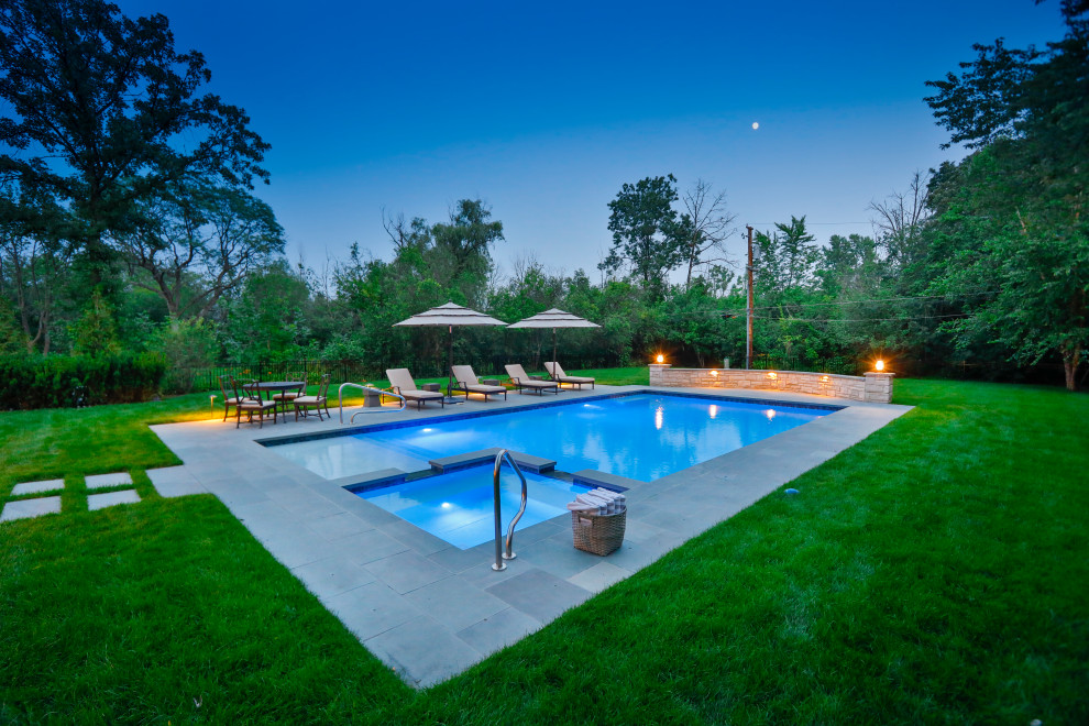 Inspiration for a medium sized traditional back private and rectangular lengths swimming pool in Chicago with natural stone paving.