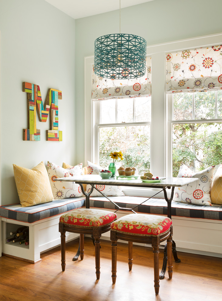 Eclectic dining room in Little Rock with blue walls, medium hardwood floors and brown floor.
