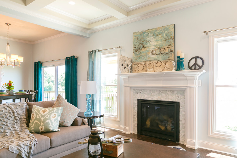 This is an example of a mid-sized traditional open concept family room in Louisville with blue walls, dark hardwood floors, a standard fireplace, a tile fireplace surround and a wall-mounted tv.