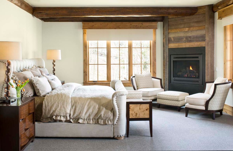 Large country master bedroom in Denver with white walls, carpet and a corner fireplace.
