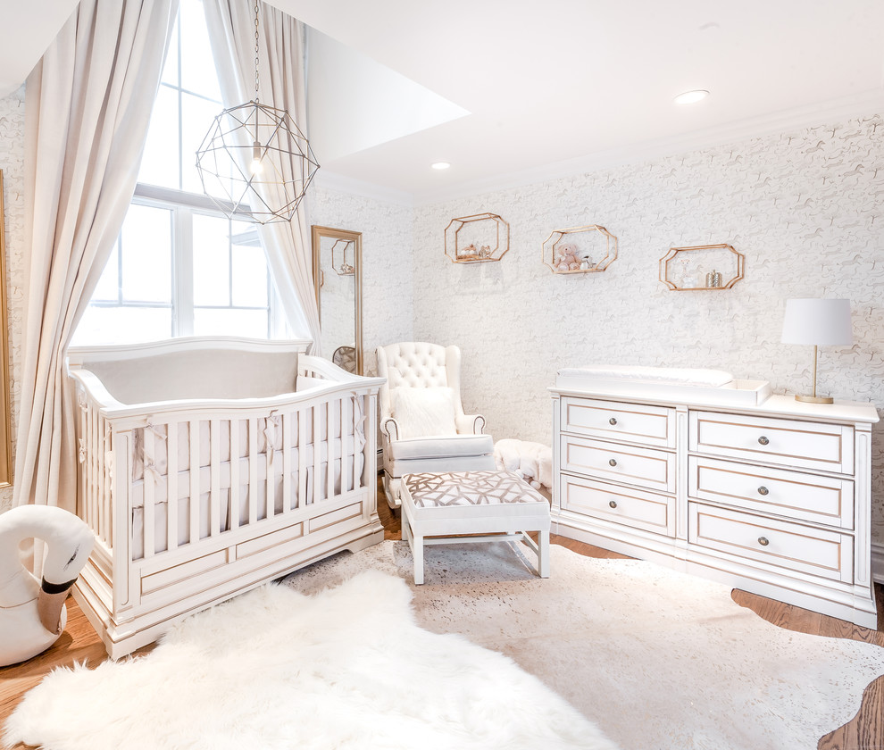 Example of a mid-sized classic girl nursery design in New York with white walls