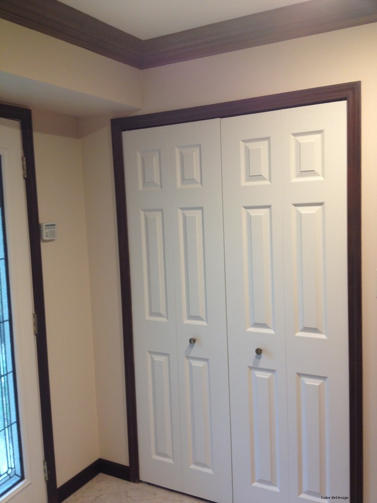 This is an example of a traditional entryway in Detroit with beige walls, ceramic floors, a double front door and a white front door.