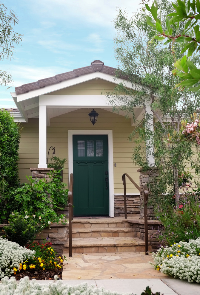 Photo of a mid-sized beach style front door in San Diego with a single front door and a green front door.