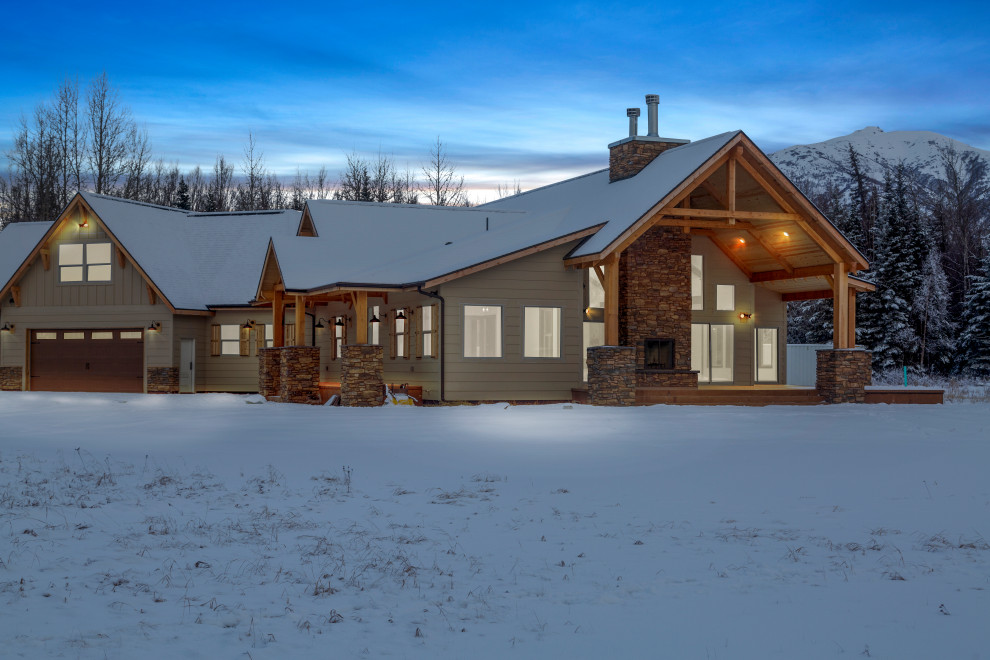 Large mountain style white two-story concrete fiberboard and board and batten house exterior photo with a butterfly roof, a shingle roof and a gray roof