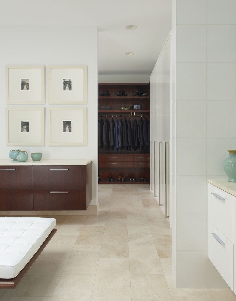 Design ideas for a contemporary dressing room in Detroit with dark wood cabinets and travertine floors.