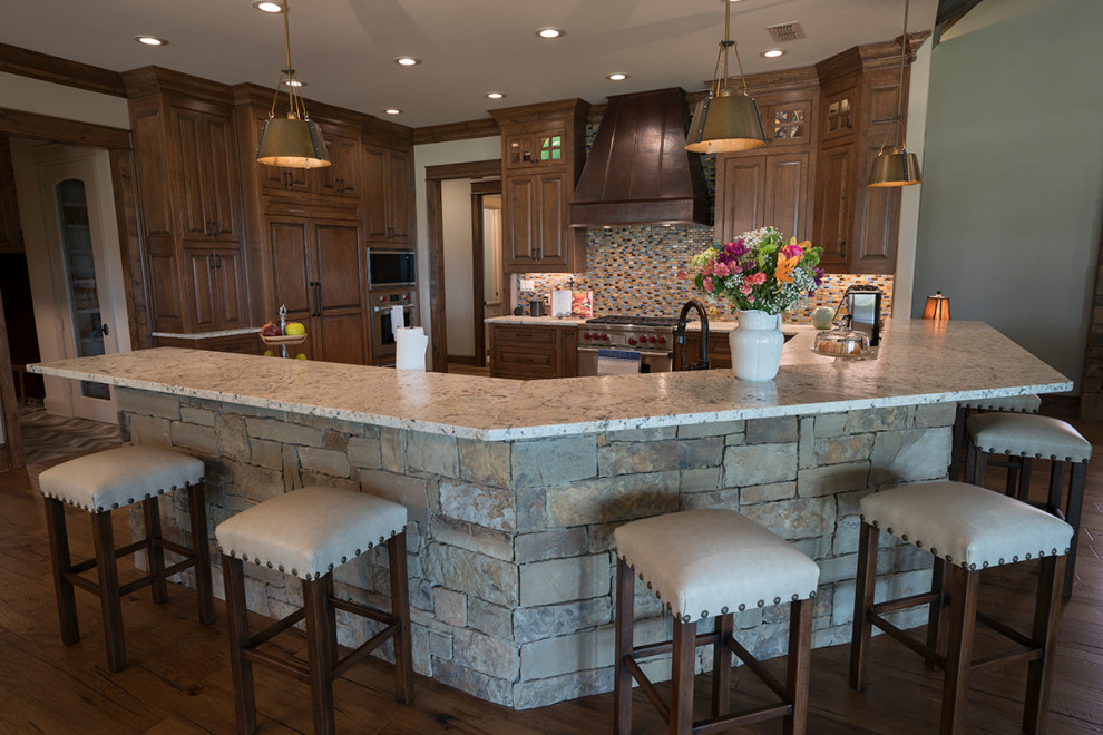 Photo of a large country u-shaped kitchen in Dallas with raised-panel cabinets, medium wood cabinets, panelled appliances and a peninsula.