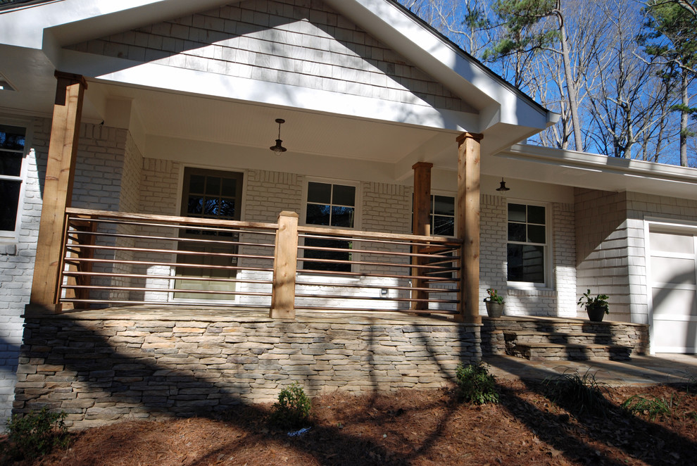 This is an example of a transitional two-storey exterior in Atlanta with mixed siding.