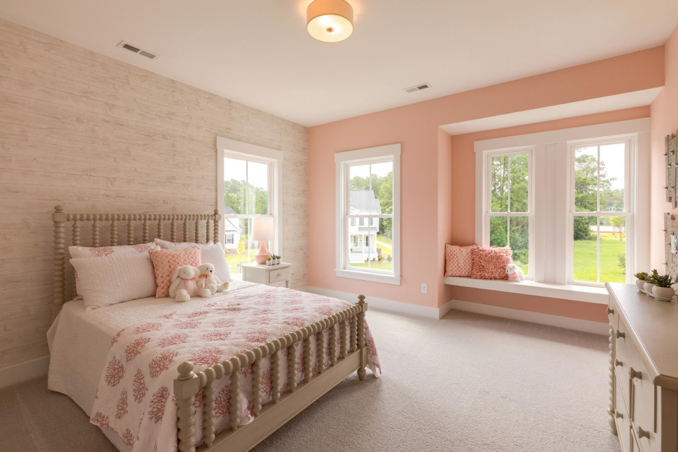 Photo of a beach style kids' bedroom for girls in Other with pink walls, carpet and grey floor.
