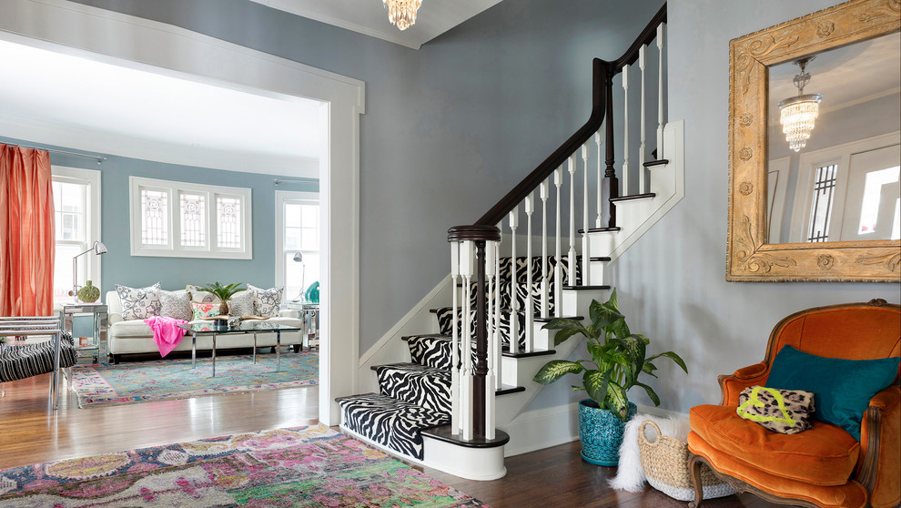 Design ideas for an eclectic foyer in Minneapolis with blue walls, dark hardwood floors and brown floor.