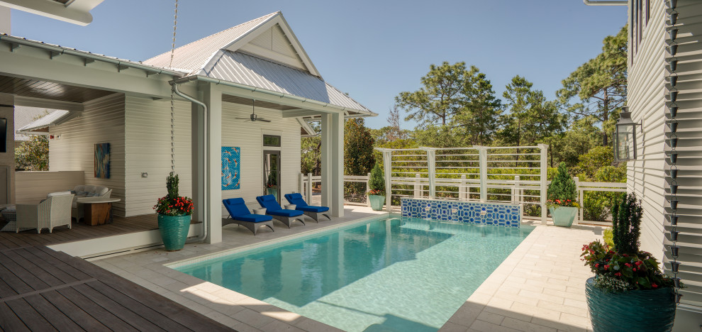 Idée de décoration pour un grand Abris de piscine et pool houses arrière marin rectangle avec des pavés en béton.