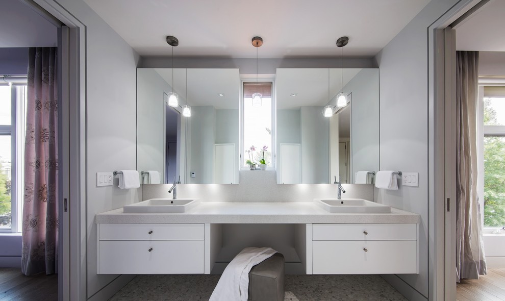 Photo of a contemporary bathroom in Miami with a vessel sink, flat-panel cabinets, white cabinets and granite benchtops.