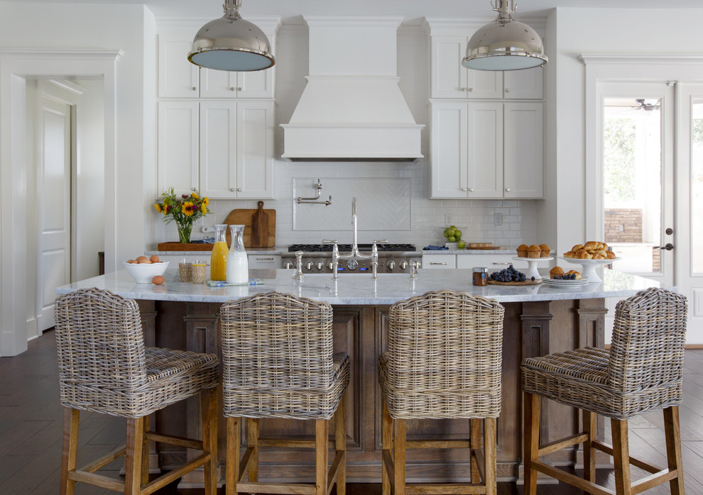 Design ideas for a country galley eat-in kitchen in Jacksonville with a farmhouse sink, white cabinets, white splashback, subway tile splashback, stainless steel appliances, dark hardwood floors, with island, shaker cabinets and marble benchtops.