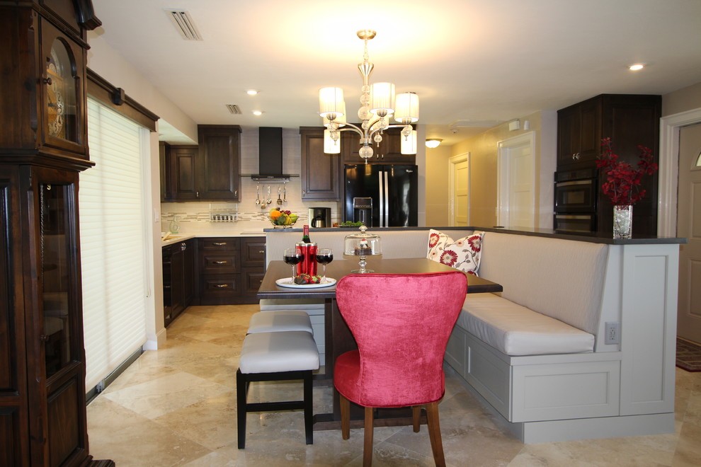 Transitional l-shaped eat-in kitchen photo in Miami with an undermount sink, flat-panel cabinets, gray cabinets, quartzite countertops, white backsplash, subway tile backsplash, black appliances and an island