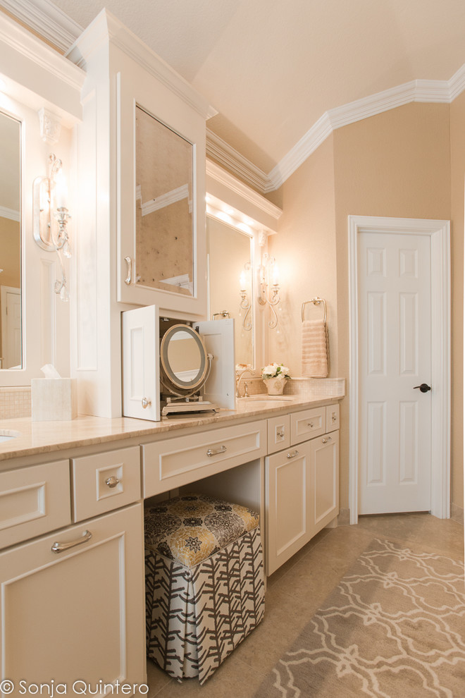 Inspiration for a large transitional master bathroom in Dallas with an integrated sink, recessed-panel cabinets, white cabinets, marble benchtops, a drop-in tub, a shower/bathtub combo, a one-piece toilet, beige tile, stone slab, beige walls and limestone floors.