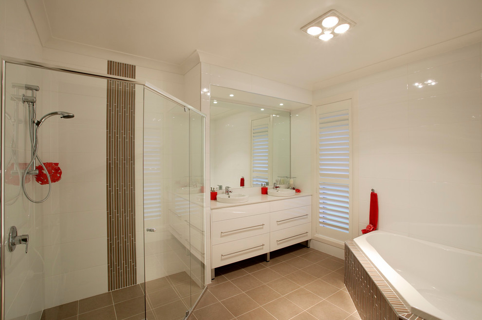 This is an example of a contemporary master bathroom in Sydney with a drop-in sink, flat-panel cabinets, white cabinets, quartzite benchtops, a drop-in tub, a corner shower, brown tile, ceramic tile, white walls and ceramic floors.
