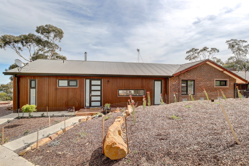 This is an example of a mid-sized contemporary one-storey exterior in Adelaide with wood siding.