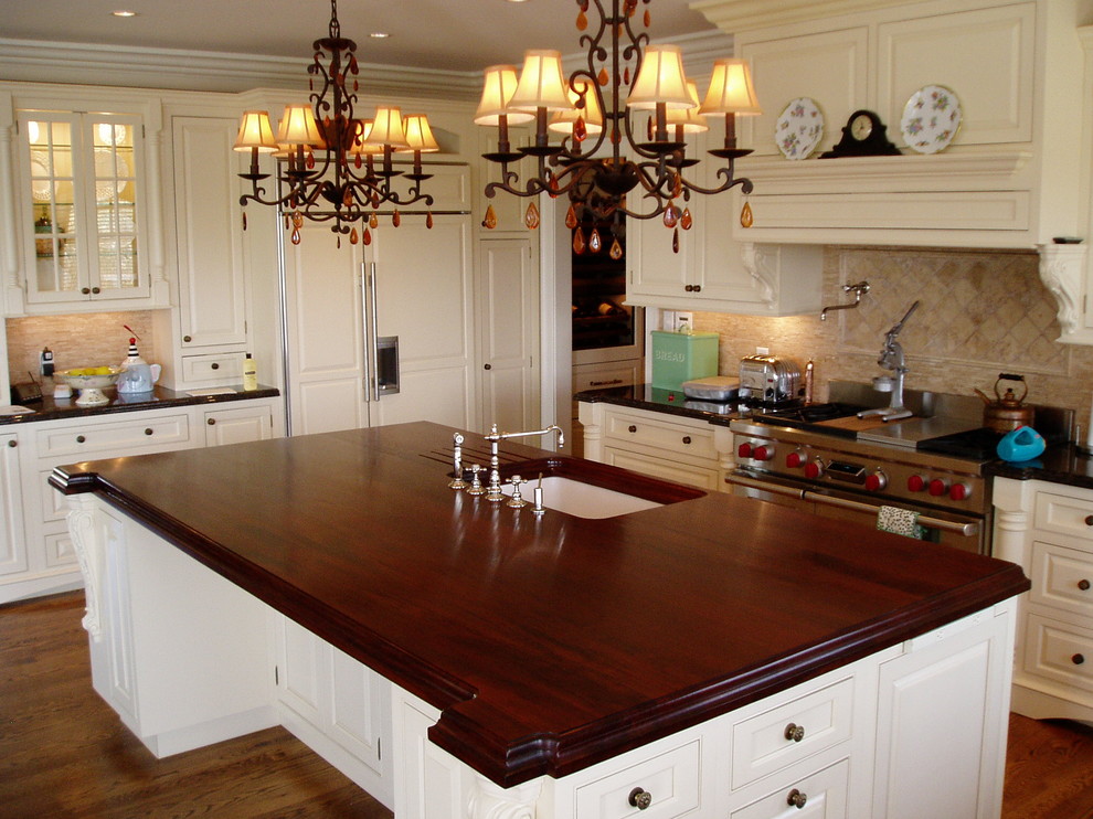 Photo of a traditional single-wall eat-in kitchen in New York with an undermount sink and wood benchtops.