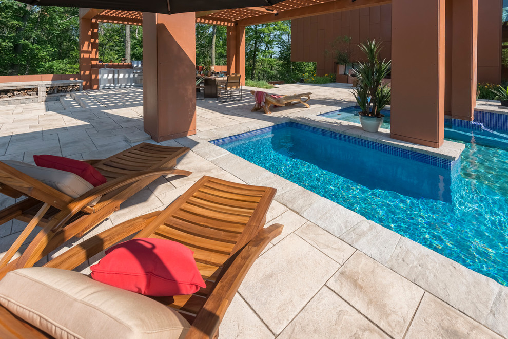 This is an example of a large traditional back swimming pool in Montreal with concrete slabs.