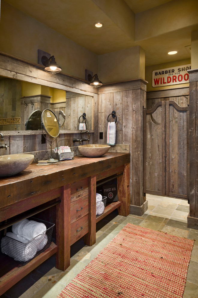 Inspiration for a country bathroom in Other with a vessel sink, flat-panel cabinets, wood benchtops, distressed cabinets and brown benchtops.