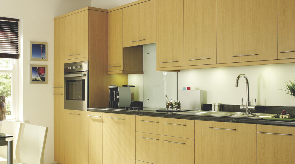 Inspiration for a contemporary kitchen in Hampshire with flat-panel cabinets, medium wood cabinets and wood benchtops.