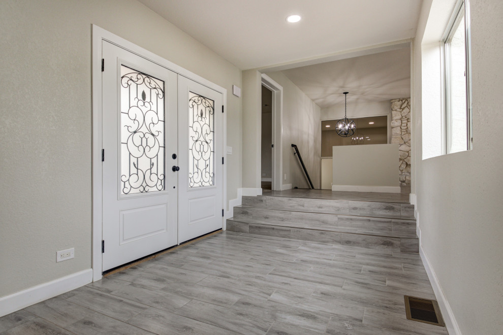 Inspiration for a mid-sized transitional porcelain tile and gray floor front door remodel in Phoenix with gray walls and a white front door