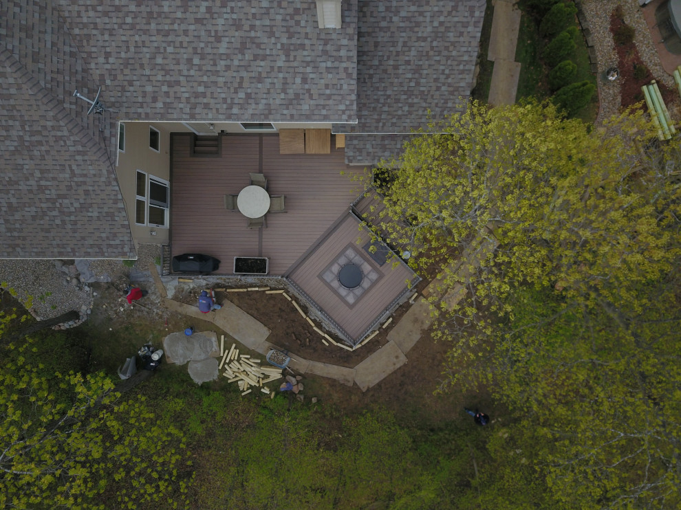 Inspiration for a large backyard ground level metal railing deck remodel with no cover