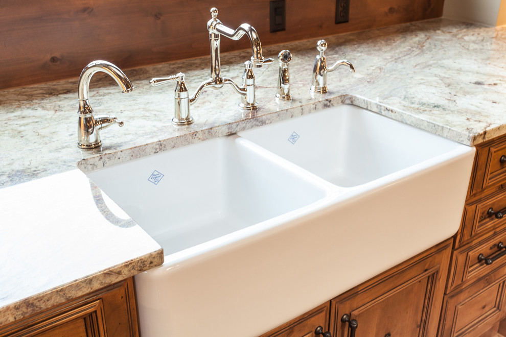 Eat-in kitchen - huge rustic u-shaped medium tone wood floor eat-in kitchen idea with a farmhouse sink, beaded inset cabinets, beige cabinets, granite countertops, beige backsplash, mosaic tile backsplash, stainless steel appliances and an island