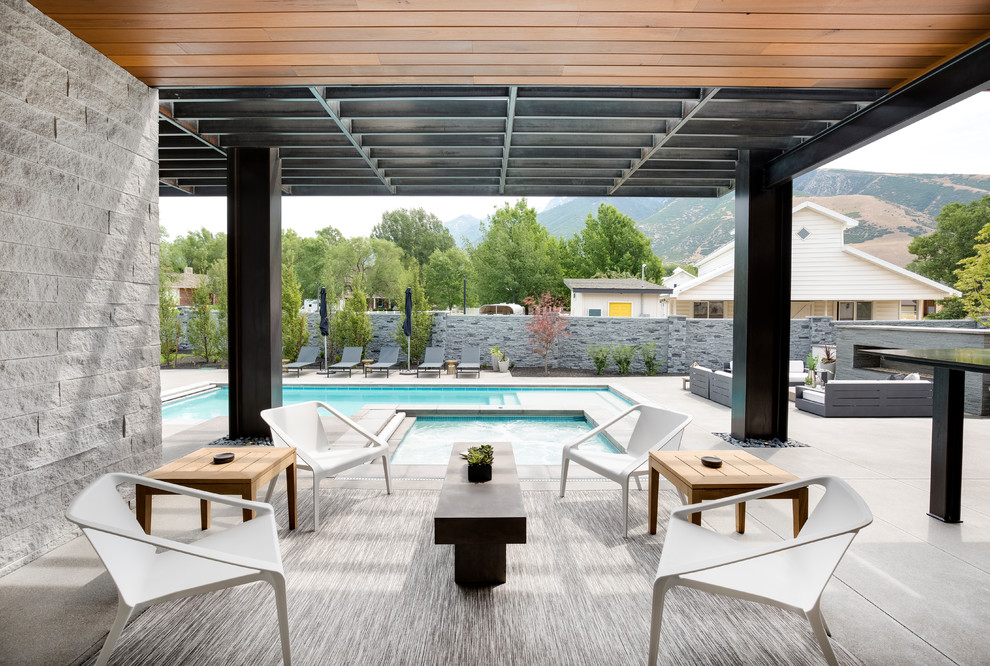 Photo of a contemporary patio in Salt Lake City with concrete slab and a pergola.