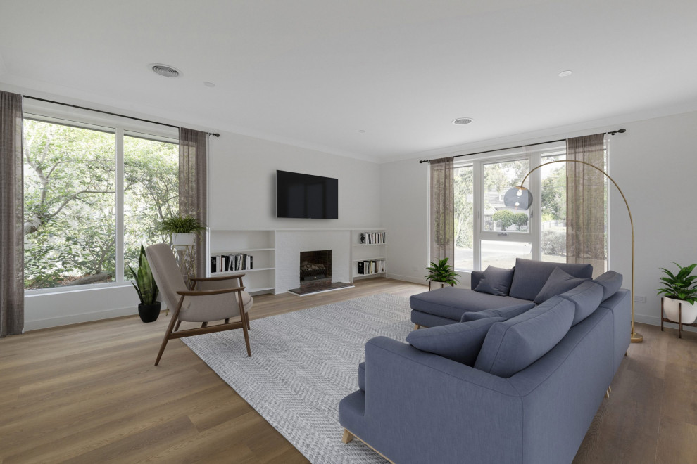 Photo of a modern living room in Melbourne with white walls, medium hardwood floors, a standard fireplace, a brick fireplace surround and brown floor.