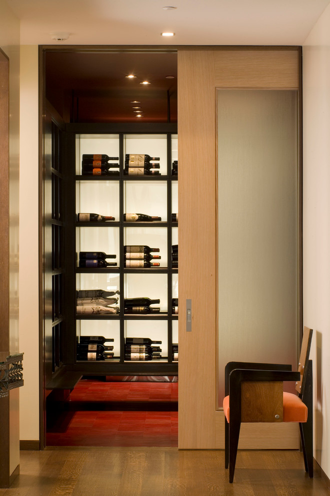 This is an example of a contemporary wine cellar in Denver with display racks.