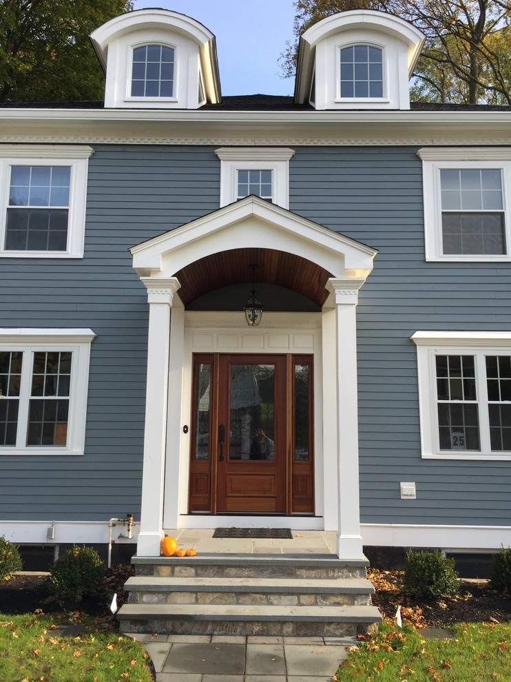 This is an example of a traditional blue exterior in Boston with concrete fiberboard siding.