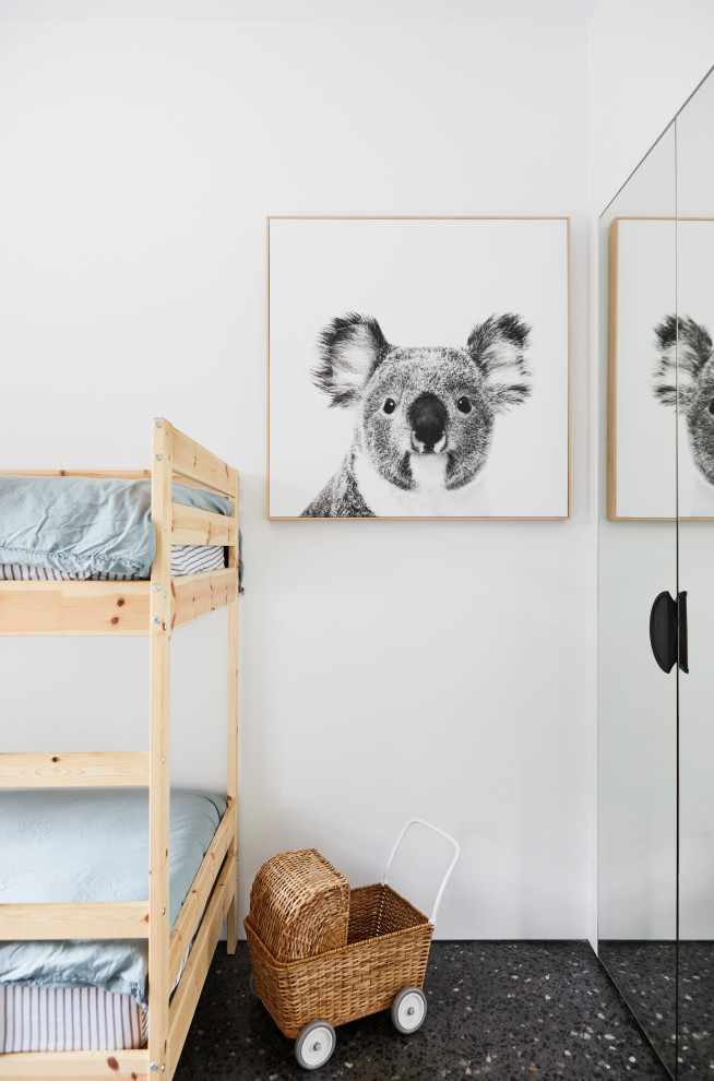 Photo of a mid-sized contemporary kids' bedroom for kids 4-10 years old and girls with white walls, concrete floors and black floor.