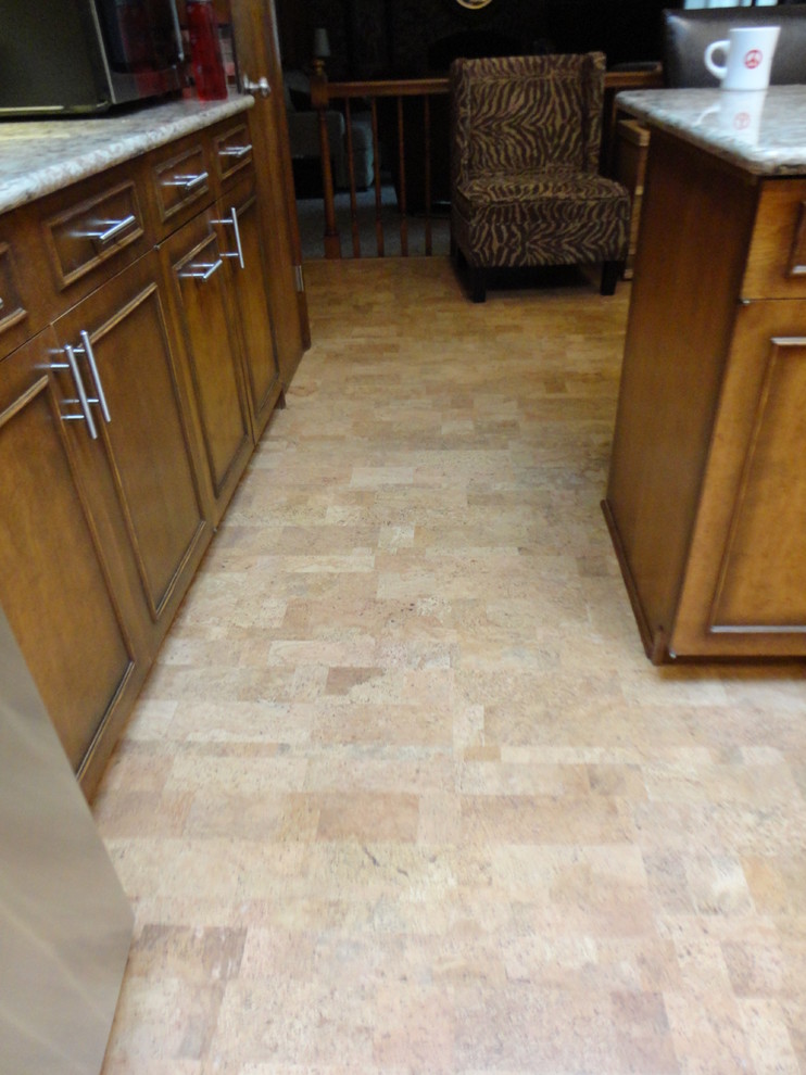 Mid-sized l-shaped cork floor enclosed kitchen photo with an undermount sink, quartzite countertops, multicolored backsplash, stainless steel appliances, beige walls and a peninsula
