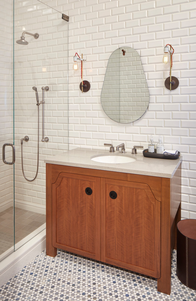 Inspiration for a transitional 3/4 bathroom in Chicago with medium wood cabinets, an alcove shower, white tile, subway tile, mosaic tile floors, an undermount sink, multi-coloured floor, a hinged shower door, grey benchtops and recessed-panel cabinets.